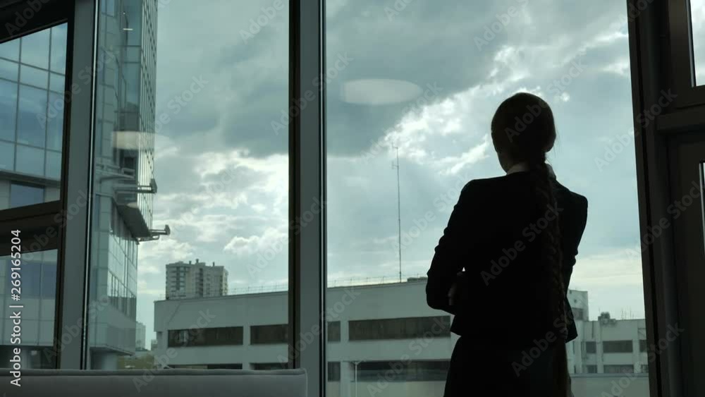 The girl comes to the window, the silhouette of a girl. Office The girl comes to the window, the silhouette of a girl. Office