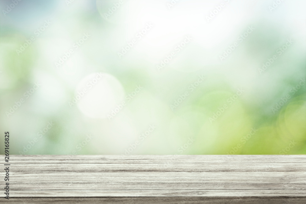 Green blurred background with wooden table Green blurred background with wooden table
