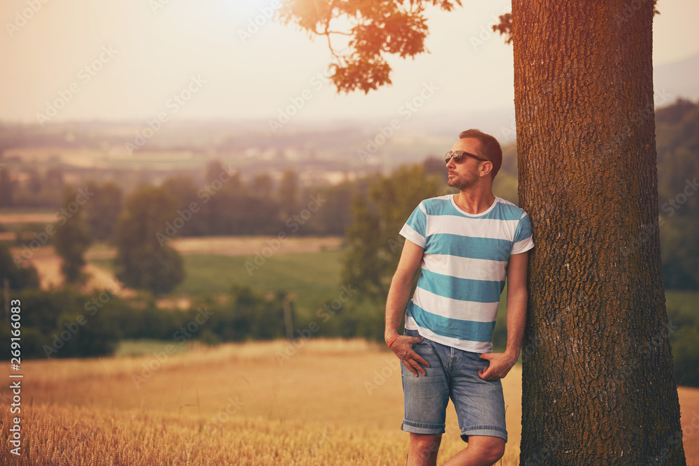 Man enjoying and relaxing in wheat field. Nature concept. Man enjoying and relaxing in wheat field. Nature concept.
