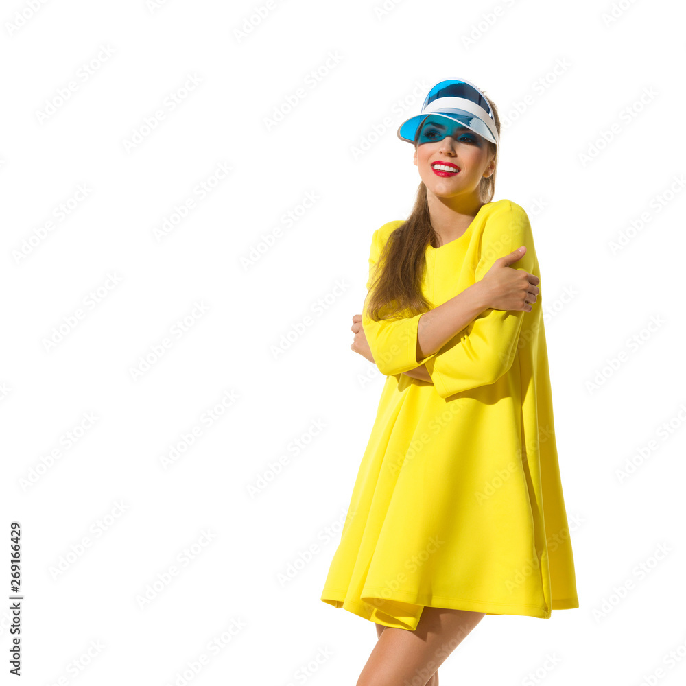 Smiling Woman In Yellow Mini Dress And Sun Visor Is Looking Away Smiling Woman In Yellow Mini Dress And Sun Visor Is Looking Away