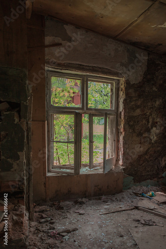 old window in an ancient brick wall in an abandoned castle, interior with light from the windows, old windows with empty frame