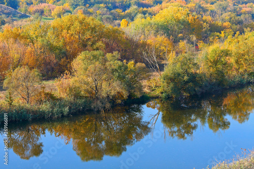 Top view of the river with rapids and autumn trees along the bank of the dawn. Autumn river landscape