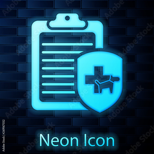 Glowing neon Clipboard with medical clinical record pet icon isolated on brick wall background. Health insurance form. Medical check marks report. Vector Illustration