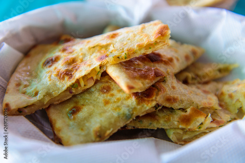 Homemade wheat paratha stuffed colliflower and onion. Gobi Paratha cutted into pieces, close up.