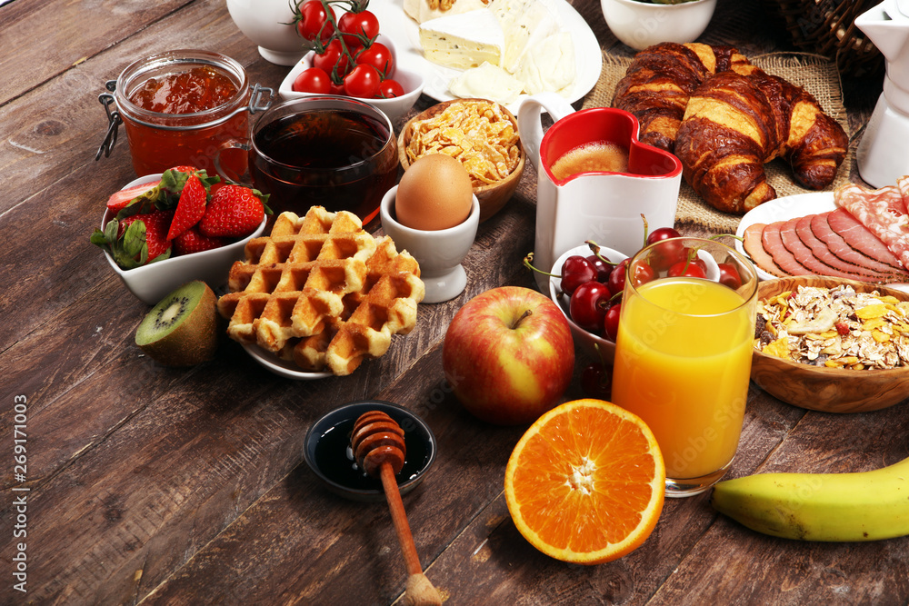 Breakfast served with coffee, orange juice, croissants and strawberry, jam and tea. breakfast table Breakfast served with coffee, orange juice, croissants and strawberry, jam and tea. breakfast table