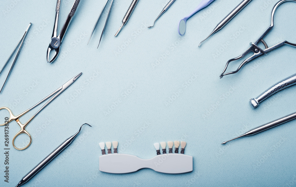 Dental steel instruments on light blue background with copy space Dental steel instruments on light blue background with copy space