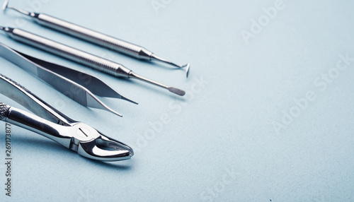 Dental steel instruments on light blue background with copy space photo