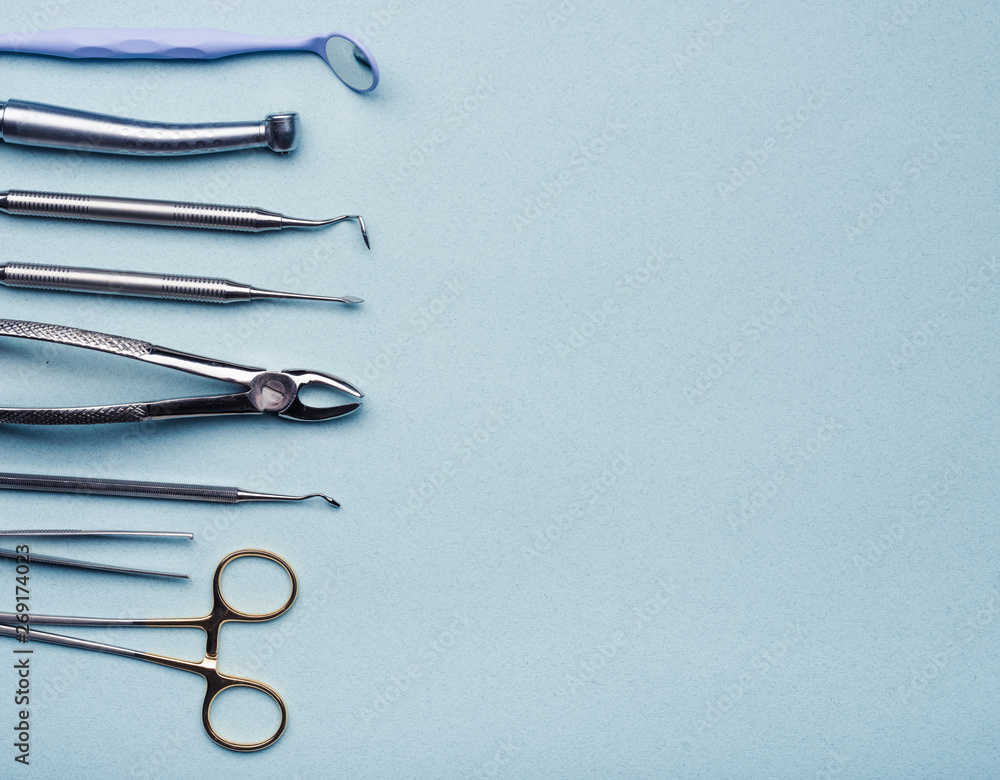 Dental steel instruments on light blue background with copy space Dental steel instruments on light blue background with copy space