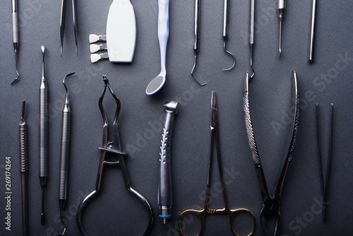 Closeup of different dental instruments composed on gray background photo