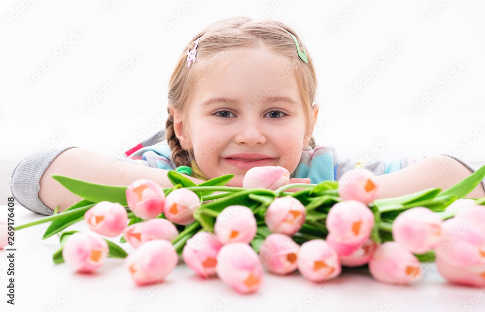 Young smiling kid with magnificent bouquet of creamy spring flowers, isolated Young smiling kid with magnificent bouquet of creamy spring flowers, isolated