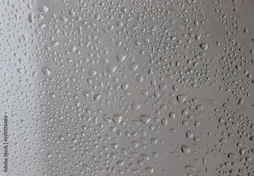 Water drops on a window glass after the rain. The sun on background. Water drops on a window glass after the rain. The sun on background.