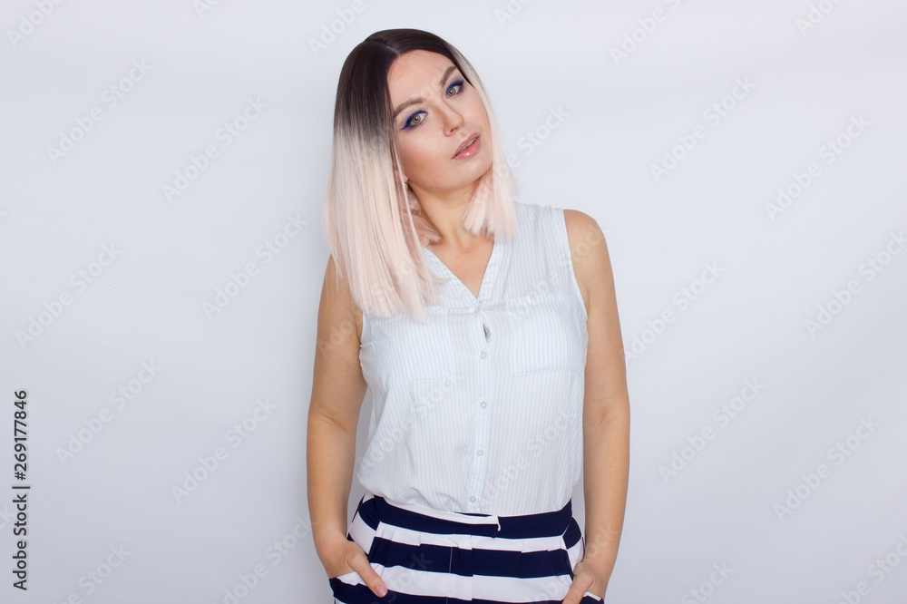 Lovely blonde woman wearing summer shorts and blouse