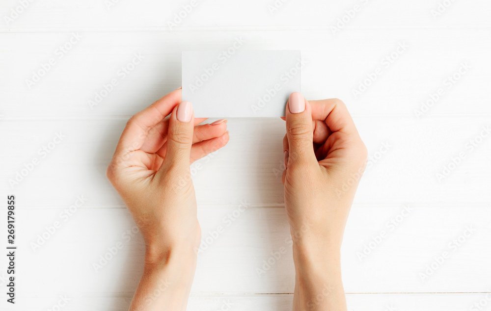Woman holding white business card in hands. Tamplate for your design. - obrazy, fototapety, plakaty 