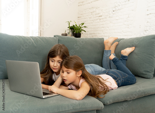 Photography Two sisters smiling and having fun together playing and surfing on the internet
