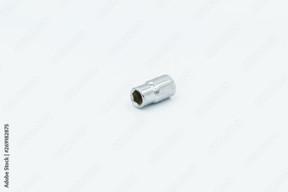 This capture of a silver socket wrench on a white background and in a studio light This capture of a silver socket wrench on a white background and in a studio light
