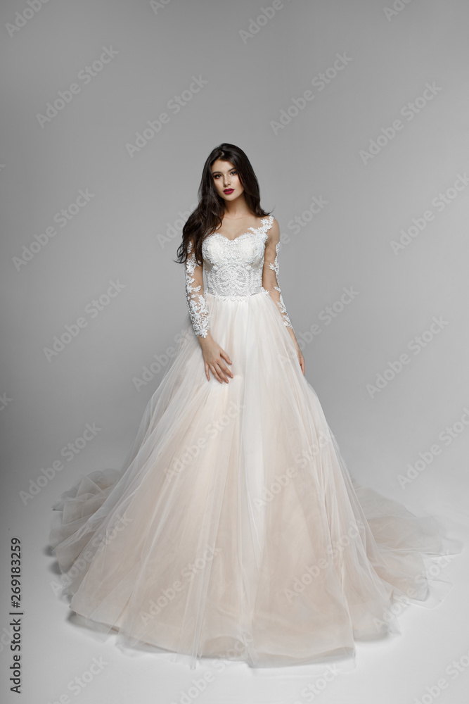 Beauty portrait of bride wearing fashion wedding dress with with luxury delight make-up and hairstyle, studio indoor photo. Young gorgeous brunette caucasian model. Beauty portrait of bride wearing fashion wedding dress with with luxury delight make-up and hairstyle, studio indoor photo. Young gorgeous brunette caucasian model.