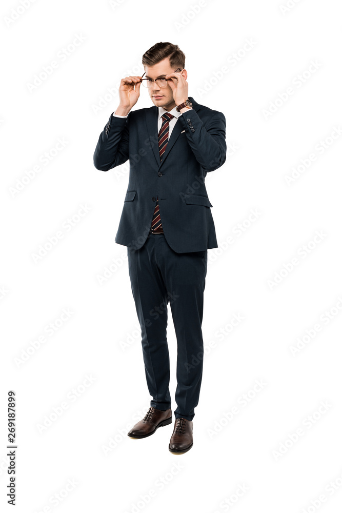 businessman in suit touching glasses and standing isolated on white businessman in suit touching glasses and standing isolated on white