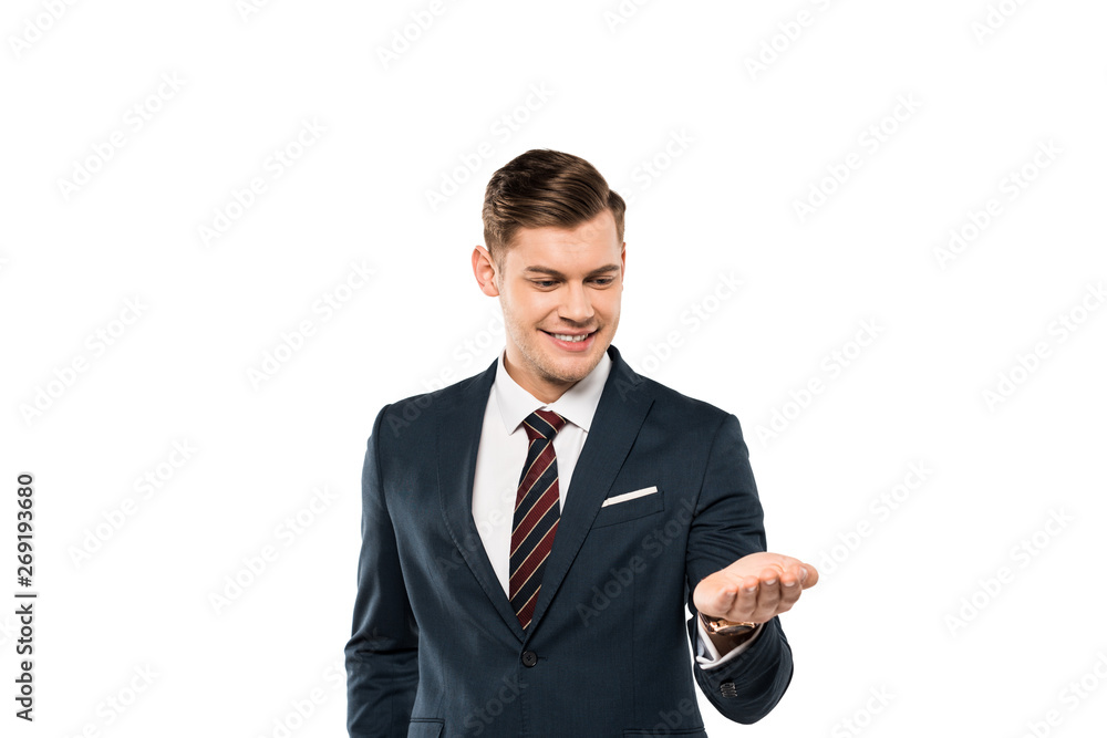 cheerful businessman in suit looking at hand isolated on white cheerful businessman in suit looking at hand isolated on white