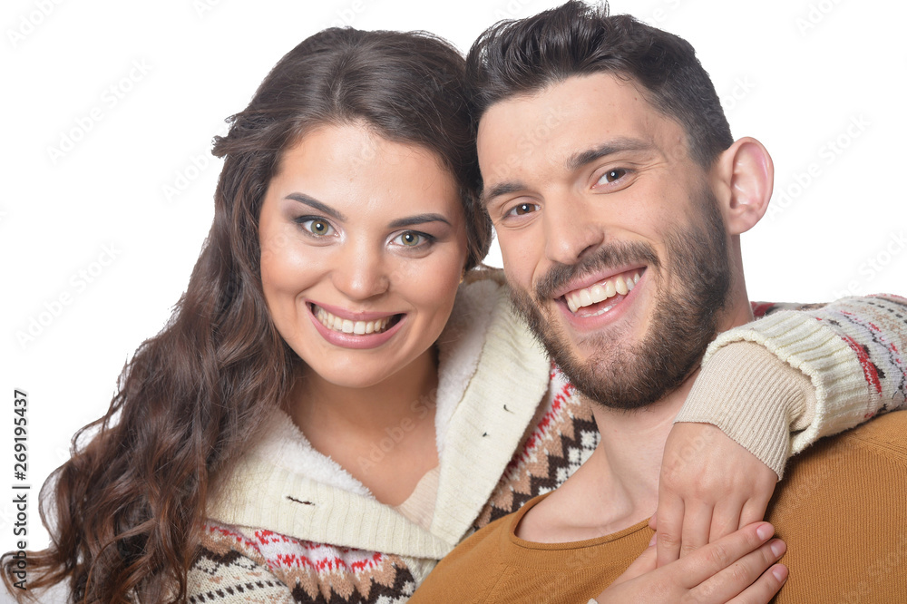 Portrait of happy young couple smiling and hugging on white background Portrait of happy young couple smiling and hugging on white background