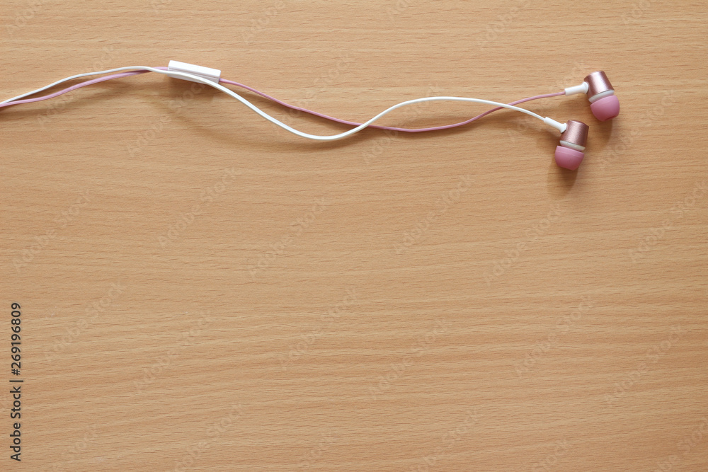 View of headphones on wooden background. View of headphones on wooden background.