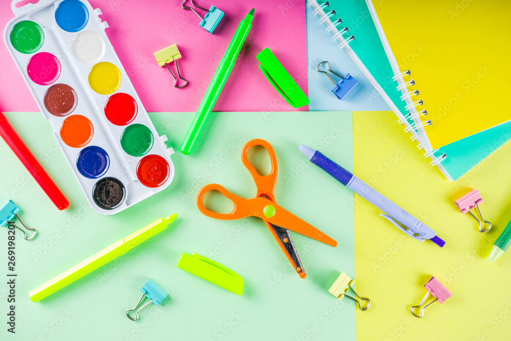Colorful back to school background. Bright background with school supplies, stationery, pens, pencils, rulers, notebooks, copy space for text, whiteboard for notes, flat lay top view Colorful back to school background. Bright background with school supplies, stationery, pens, pencils, rulers, notebooks, copy space for text, whiteboard for notes, flat lay top view
