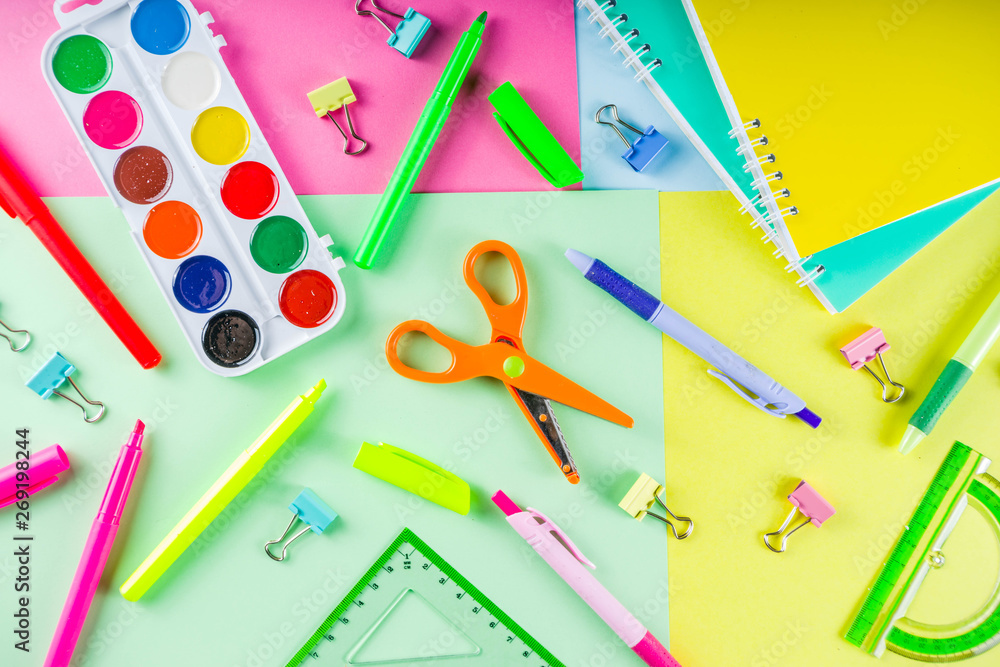 Colorful back to school background. Bright background with school supplies, stationery, pens, pencils, rulers, notebooks, copy space for text, whiteboard for notes, flat lay top view Colorful back to school background. Bright background with school supplies, stationery, pens, pencils, rulers, notebooks, copy space for text, whiteboard for notes, flat lay top view