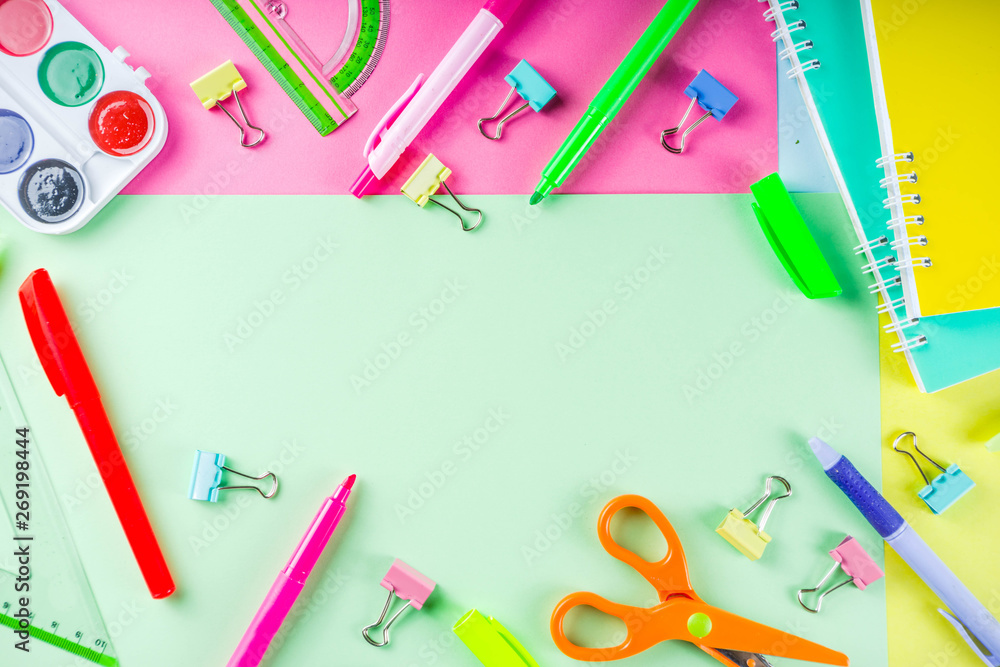 Colorful back to school background. Bright background with school supplies, stationery, pens, pencils, rulers, notebooks, copy space for text, whiteboard for notes, flat lay top view Colorful back to school background. Bright background with school supplies, stationery, pens, pencils, rulers, notebooks, copy space for text, whiteboard for notes, flat lay top view