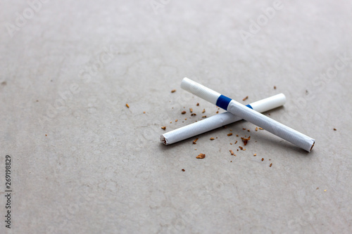 world no tobacco day concept. closeup cigarette on cement floor with soft-focus and over light in the background