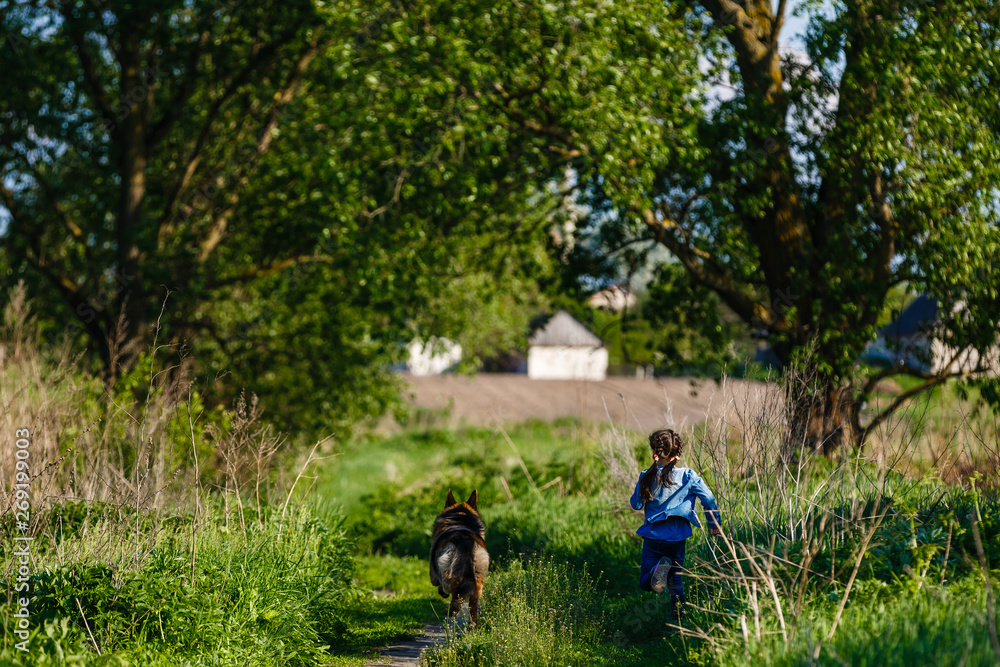 Lucky to be together. Full length of cute little girl running with dog and smiling Lucky to be together. Full length of cute little girl running with dog and smiling