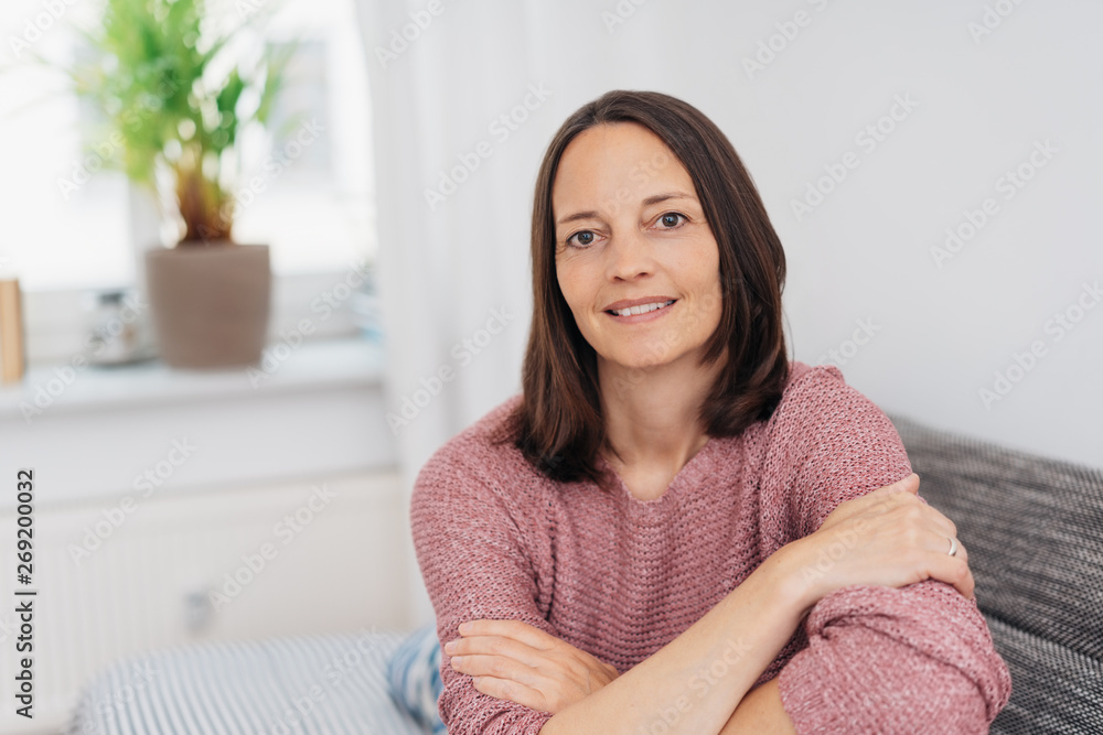 Smiling happy relaxed woman relaxing on a sofa Smiling happy relaxed woman relaxing on a sofa