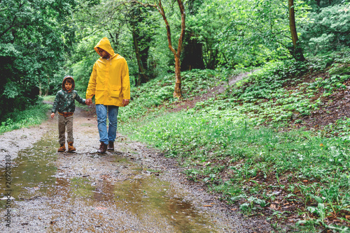 Father and son walking in the rain