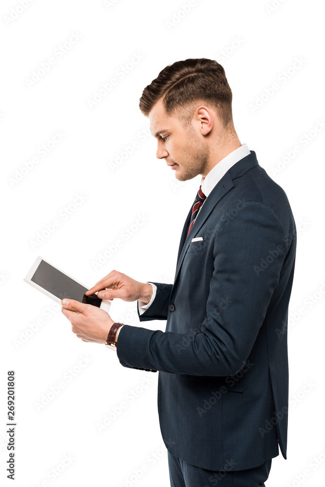 handsome businessman pointing with finger at digital tablet isolated on white