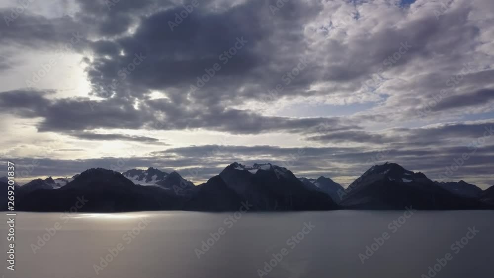 The mountain islets on the sea in Norway with the dark clouds on the sky The mountain islets on the sea in Norway with the dark clouds on the sky