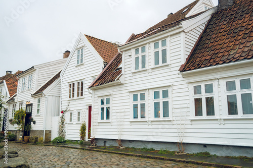 Beautiful street with traditional white wooden houses in Stavanger, Norway. Summer