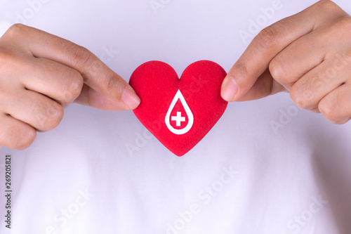Woman hands holding red heart with donor sign for blood donation concept,World blood donor day. Copy space for advertisers.