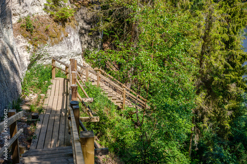 natural sand stone cliffs on the shore of the river in forest