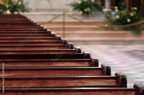 Rows of church benches. Polished wooden pews. Selective focus.