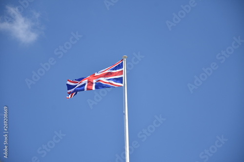 waving UK flag in the blue sky, Union Jack flag
