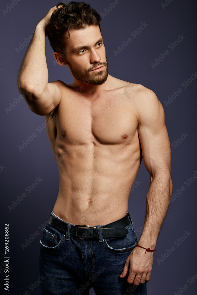 strong athletic young bodybuilder showing six pack abs, holding his hand on head and looking aside.isolated black background, beauty, free time strong athletic young bodybuilder showing six pack abs, holding his hand on head and looking aside.isolated black background, beauty, free time