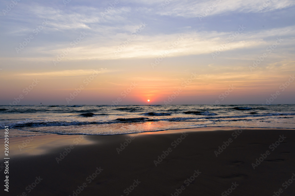 Beautiful sky colorful sunset on the ocean, natural landscapes. Deserted beach, the sun sets in the clouds above the sea.