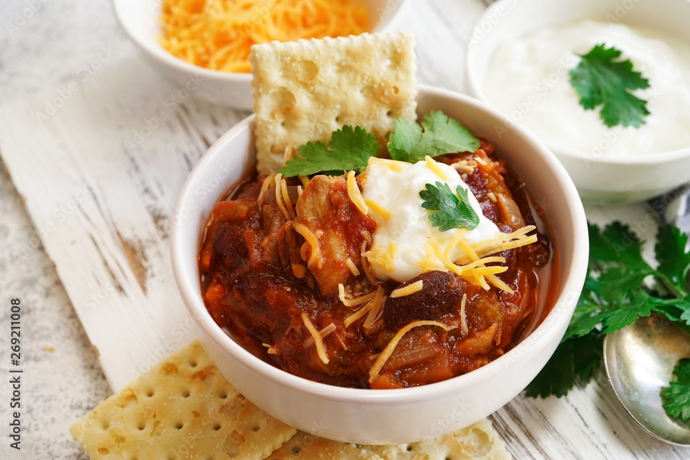 Homemade Chili bowl served with crackers, selective focus Homemade Chili bowl served with crackers, selective focus