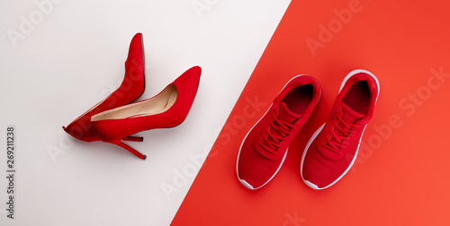 Fotografia A studio shot of pair of running vs high heel shoes on color background