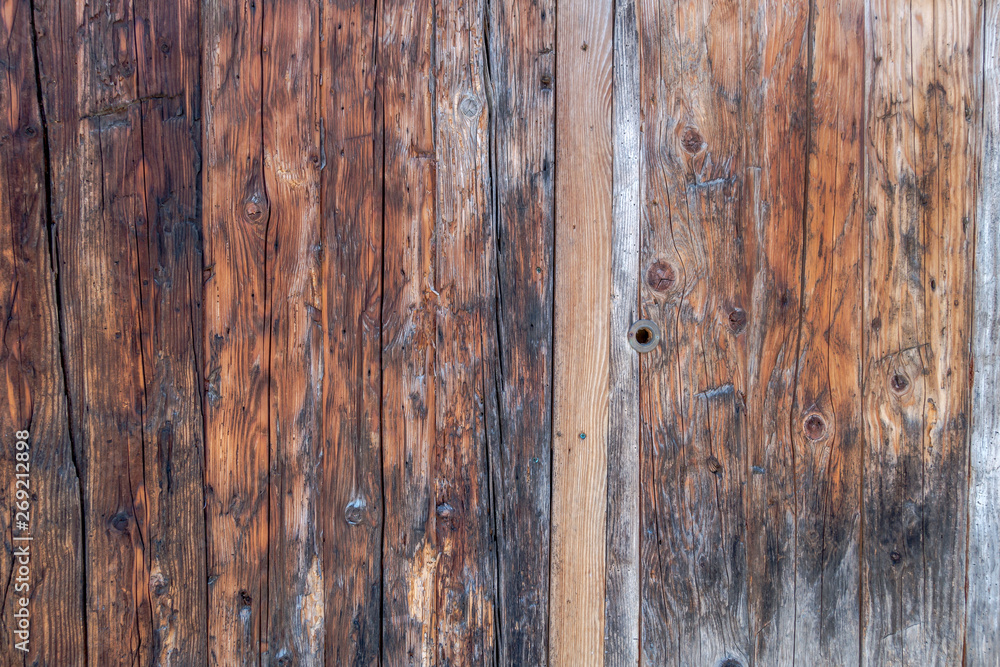 Closeup of traditional weathered outhouse wood panel doors with keyhole Closeup of traditional weathered outhouse wood panel doors with keyhole