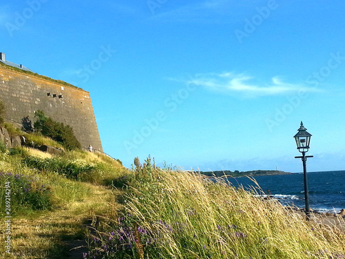 Beautiful landscape. The sea, the wall of the fortress Varberg and clear sky