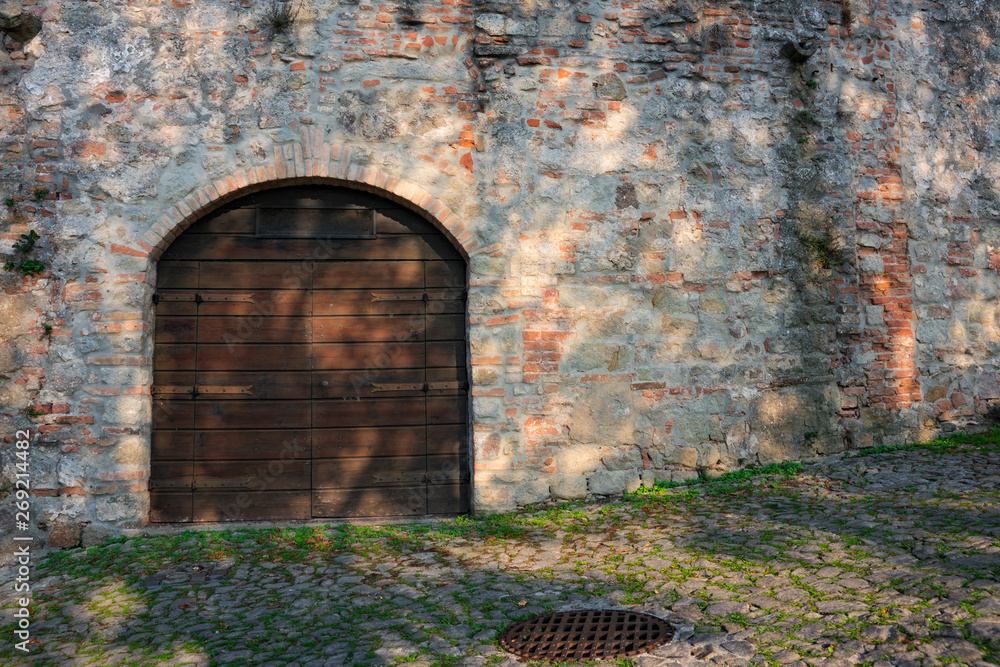 wooden door in city wall in Monselice, Italy wooden door in city wall in Monselice, Italy