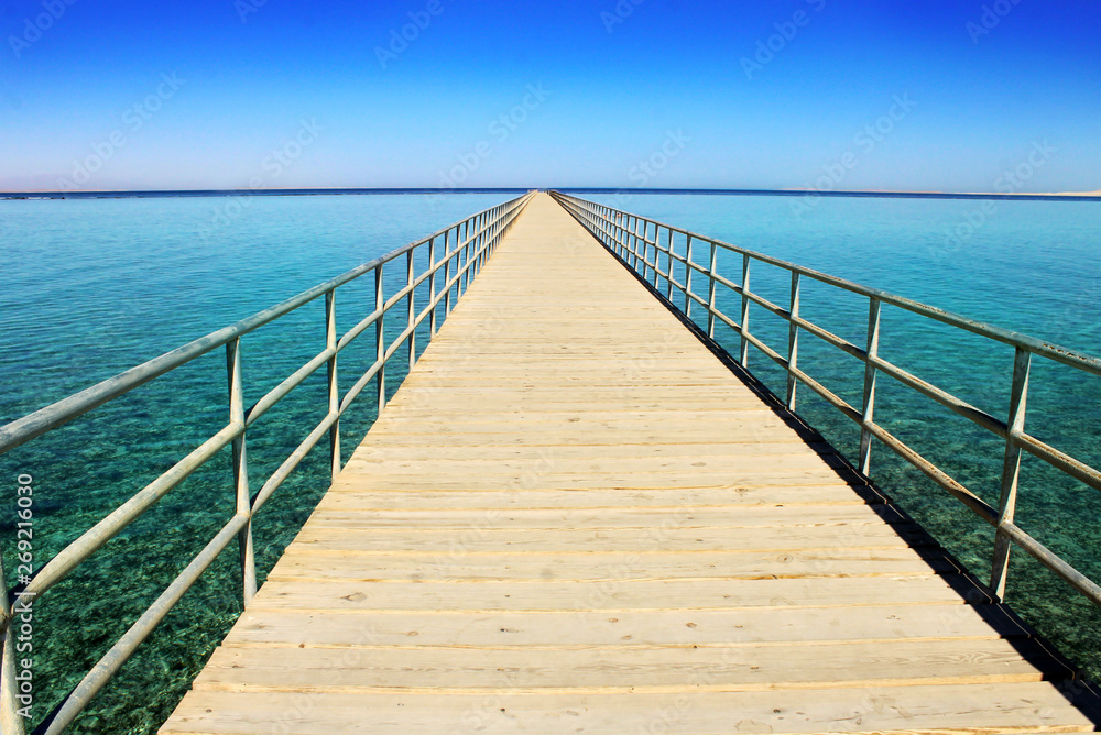 Panoramic image of a wooden bridge in the sea. Panoramic image of a wooden bridge in the sea.