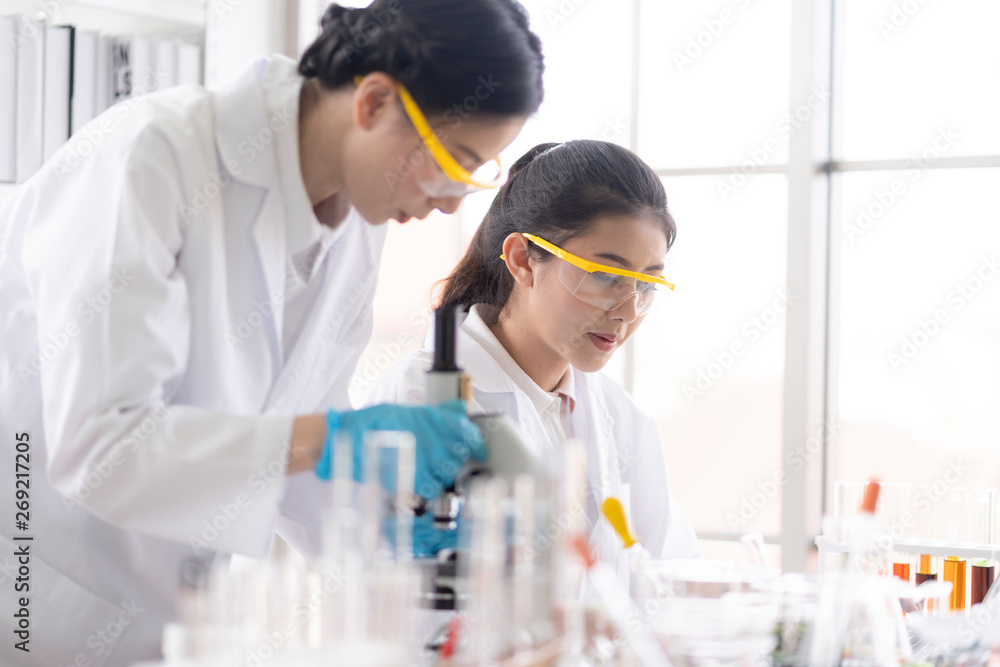 Female scientists are preparing microscopes for testing and analysis through an extension to find the results of medical research. Scientific and chemical concepts Female scientists are preparing microscopes for testing and analysis through an extension to find the results of medical research. Scientific and chemical concepts