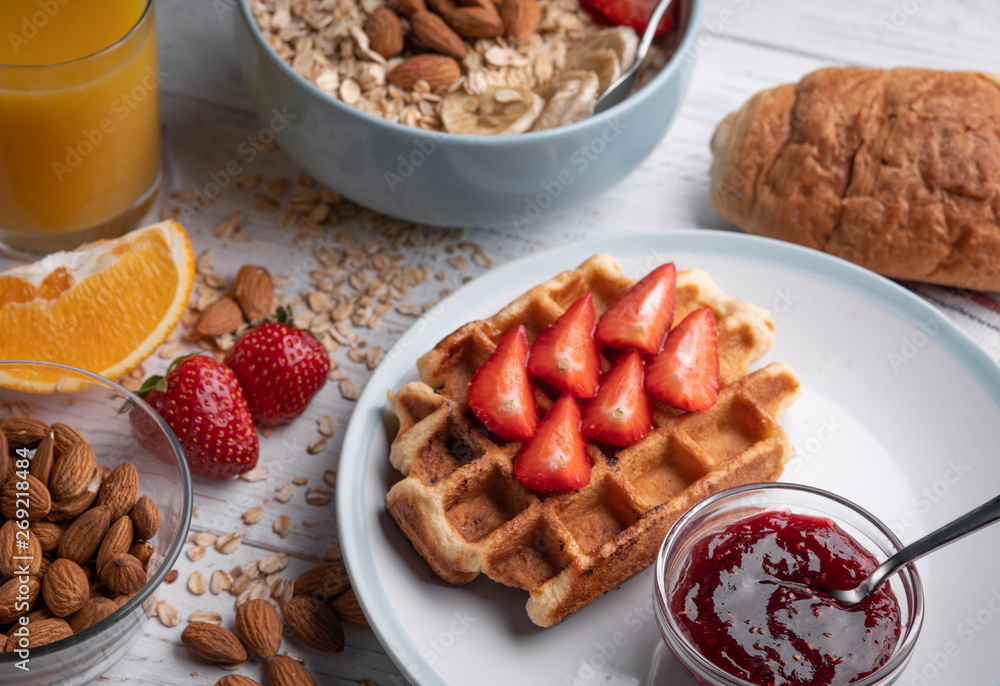 Oatmeal porridge and belgian waffle with fruit and nuts on white background. Morning delicious muesli, croissant. Food set. Oatmeal porridge and belgian waffle with fruit and nuts on white background. Morning delicious muesli, croissant. Food set.