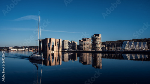 Landscape of buildings near the pier. Yacht on the background of new buildings