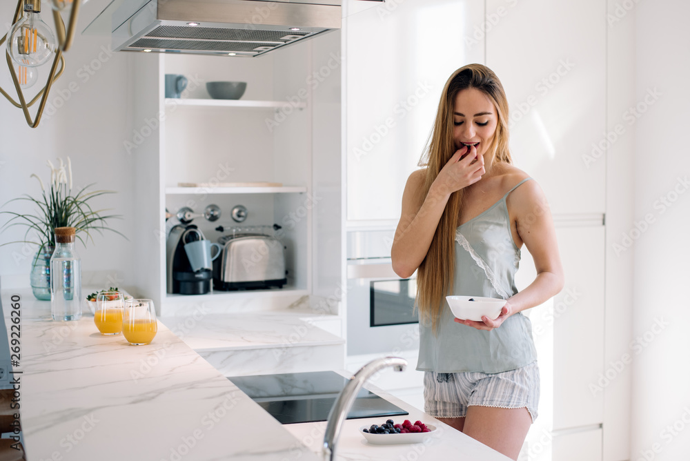 Woman having breakfast at home